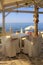 White tables and chairs on sea coast, Crete, Greece.