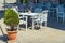 white tables and chairs of a street european cafe