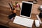 White Tablet With Blank Screen On Wooden Desk With Stationery Objects