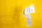 White tags with the percent sign hang on strings on a yellow background with shadows. Commerce, discount, sale, trade offer. Copy