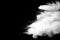 White talcume powder explosion on black background. White dust particles splash