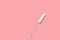 White tampon on pink background. Isolated on pink. Woman`s hygiene and health