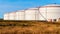 White tanks in tank farm with blue sky