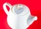 White teapot with heart tied with a cord isolated on red background. Love tea