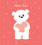 White teddy bear holding heart. I love you.