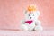 White teddy bear toy with orange flower barrette on head