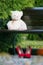 White Teddy bear on a wooden bench in the Park.