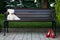 White Teddy bear on a wooden bench in the Park.