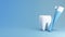 White teeth, toothbrush and toothpaste tube for product presentation isolated on blue background,