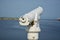 A white telescope on a ship in the sun