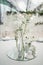 White and tender wedding reception table arrangement, floral centerpiece.