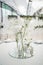 White and tender wedding reception table arrangement, floral centerpiece.