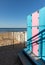 White tents and blue pink lockers at the beach