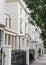 White terraced houses on a street in London, UK