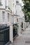 White terraced houses on a street in London, UK