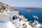 White terraces of Santorini and ships on the blue ocean.