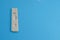white test strip for the diagnosis of coronavirus infection. test on a blue background. individual kit for the diagnosis of the