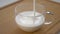 White thick kefir or yogurt is poured into a glass cup