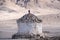 A white Tibetan stone stupa with mountain view