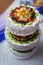 White tiered cake with chunks of berries and fruits
