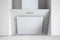 White tilted two-layer cooker hood with five silver buttons, located between two hanging cabinets. Simple light modern kitchen