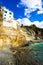 White tiny house on coastline rock in Vernazza