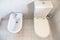 White toilet with bowl drain and bidet