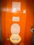 White toilet in a lovely orange toilet room