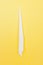 White toothpick on a yellow background