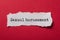 White torn paper on red paper background with text - Sexual harassment