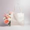 White tote bag mockup with flowers.