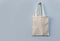 White tote canvas fabric eco bag cloth shopping sack on wall background / Zero waste