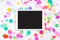 White touchpad with blank screen with colorful confetti. Colorful confetti background with tablet computer. Flat lay