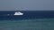 White tourist boat in the sea near reef