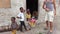 A white tourist communicates with local African people in the village, Zanzibar