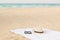 White towel on the beach with sunglasses and hat