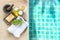 White towel with nature soap and massage oil and wooden mortar