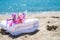 White towels and flowers with ocean scene. Stacked white spa towels on the blue Indian ocean background. Maldives luxury resort