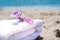 White towels and flowers with ocean scene. Stacked white spa towels on the blue Indian ocean background. Maldives luxury resort