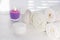 White towels scented candle with lavender scent cream jar on white background for cosmetic procedures