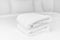 The white towels were neatly folded and placed on the white bed. Hotel services