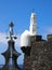 The white tower of the historic fortress in puerto de la cruz in tenerife with church bell tower and weather vane