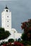 White tower of minaret against of blue sky