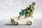 White toy car with Christmas tree on roof on a silvered background New Year 2022