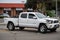 A white Toyota Tacoma truck sits in the middle of the road after an accident