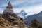 White traditional Tibetan stupa in front of Ama Dablam mountain peak in Everest base camp trekking route, Himalaya mountains range