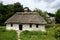 White traditional Ukrainian rural wooden house with hay roof