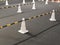 White traffic cones standing with cone bar for driving school. Close up