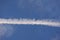 White trail from commercial airplanes, another plane flying, white moon near - chemtrails conspiracy theory concept