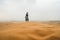White traveler girl walking on a stormy sandy day in the Sahara Desert, in Morocco
